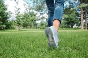 Female legs walking on grass